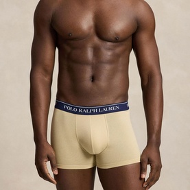 Model wearing Ralph Lauren Classic Stretch Trunk 5-Pack in tan with navy logo elastic waistband, trunk style with contoured pouch