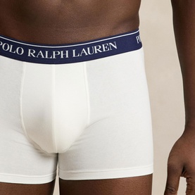Model wearing Ralph Lauren Classic Stretch Trunk 5-Pack in white with navy logo elastic waistband, contoured pouch, trunk style