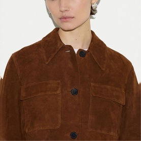 Model wearing brown suede jacket with button-front fastening, pointed collar, and chest patch pockets