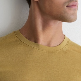 Model wearing Reiss yellow crew neck T-shirt, close-up of neckline detail
