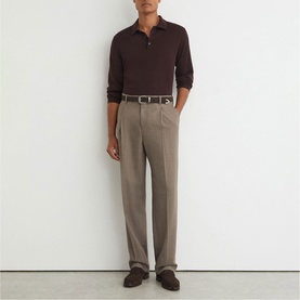 Model wearing Reiss red long-sleeve polo shirt with taupe pleated trousers, leather belt, and dark brown shoes.