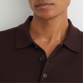 Model wearing Reiss red knit polo shirt, close-up of collar and button placket detail