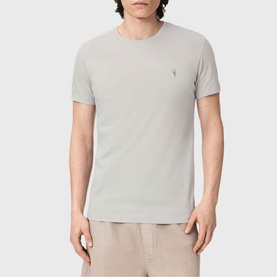 Model wearing All Saints Tonic Ramskull Logo T-Shirt in Pebble Grey, short sleeves, crew neck with small logo embroidery.