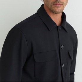 Model wearing Reiss navy blue overshirt jacket with button front, chest patch pockets and spread collar, close-up detail view