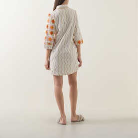Model wearing Chelsea Peers Sunshine Tile Print Night Dress in Sunshine Grid, showing back view with tile print, three-quarter sleeves and curved hem