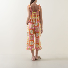 Model wearing Chelsea Peers Tropical Patchwork Print Cheesecloth Pyjama Set, tropical grid print cami and capri trousers, back view, styled with