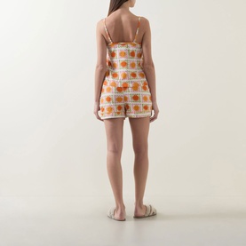 Model wearing Chelsea Peers Sunshine Tile Print Shorts Pyjama Set in Sunshine Grid, showing back view of cami and shorts with spaghetti straps
