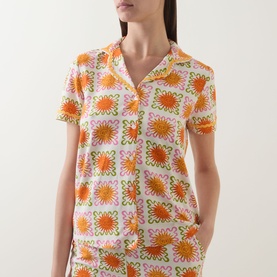 Model wearing Chelsea Peers Sunshine Tile Print Pyjama Set in Sunshine Grid, showing short-sleeve top with revere collar and ricrac trim detail
