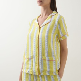 Model wearing Chelsea Peers Wiggle Stripe Cheesecloth Pyjama Set top, yellow stripe, revere collar, short sleeves, front buttons, patch pockets