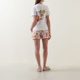 Model wearing Chelsea Peers Siesta Tiger Print Shorts Pyjama Set in Fiesta Siesta All Over Print, back view showing tiger graphic tee and floral