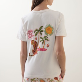 Model wearing Chelsea Peers Siesta Tiger Print Pyjama Set in Fiesta Siesta print, back view showing tiger, palm tree and sun graphic on white tee.
