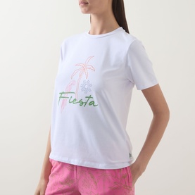 Model wearing Chelsea Peers Fiesta Pyjama Set white crew neck tee with Fiesta palm tree graphic, styled with pink printed shorts.