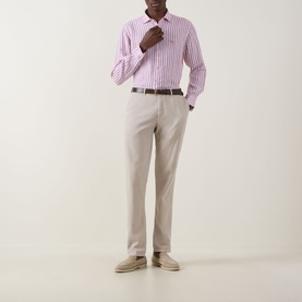 Model wearing Rodd & Gunn Seadown Stripe Shirt in RoseWater, styled with stone chinos, brown belt and beige suede loafers.