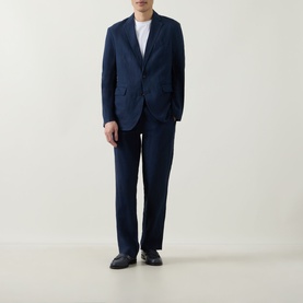 Model wearing Rodd & Gunn Campbell Island Single-Breasted Blazer in navy linen, styled with matching navy trousers and white T-shirt.