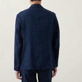 Model wearing Rodd & Gunn Campbell Island Single-Breasted Blazer in navy linen, rear view showing single vent and relaxed fit.