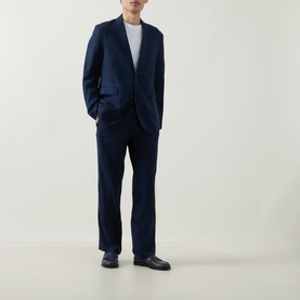 Model wearing Rodd & Gunn Campbell Island Single-Breasted Blazer in navy linen, styled with matching navy trousers and dark loafers.
