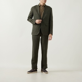 Model wearing Rodd & Gunn Campbell Island Single-Breasted Blazer in Dark Olive linen, styled with matching trousers and a brown shirt.