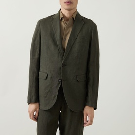 Model wearing Rodd & Gunn Campbell Island Single-Breasted Blazer in Dark Olive linen, styled with matching trousers and a brown shirt.
