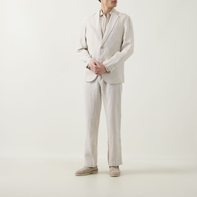 Model wearing Rodd & Gunn Campbell Island Single-Breasted Blazer in Oatmeal linen, styled with matching stripe trousers and beige loafers.
