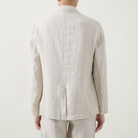 Model wearing Rodd & Gunn Campbell Island Single-Breasted Blazer in Oatmeal linen, rear view showing single vent, styled with matching trousers.