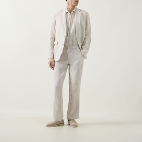 Model wearing Rodd & Gunn Campbell Island Single-Breasted Blazer in Oatmeal linen, styled with matching trousers and suede loafers.