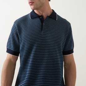 Model wearing Rodd & Gunn Oyster Island Striped Knitted Polo Shirt in teal, with navy contrast collar and cuffs, short sleeves