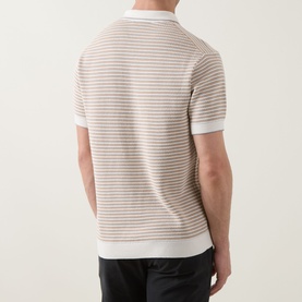 Model wearing Rodd & Gunn Oyster Island Striped Knitted Polo Shirt in Acorn, rear view, with black trousers.