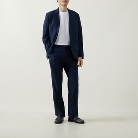 Model wearing Rodd & Gunn Spencer Bay Linen Trousers in navy, styled with matching navy blazer, white tee and dark loafers.