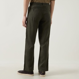 Model wearing Rodd & Gunn Spencer Bay Linen Trousers in Dark Olive, rear view showing buttoned jet pockets and belt loops.
