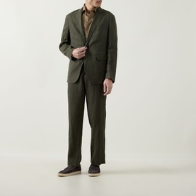 Model wearing Rodd & Gunn Spencer Bay Linen Trousers in Dark Olive, styled with matching linen blazer and brown shirt.