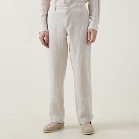 Model wearing Rodd & Gunn Spencer Bay Linen Trousers in Oatmeal, styled with a cream top and tan loafers.
