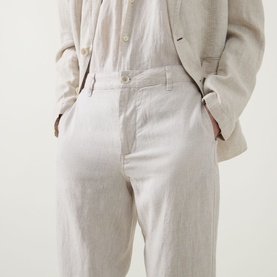 Model wearing Rodd & Gunn Spencer Bay Linen Trousers in Oatmeal, styled with matching linen blazer, hands in pockets, close-up rear view.