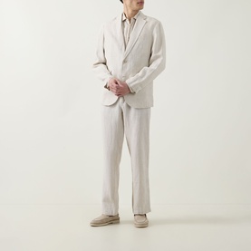 Model wearing Rodd & Gunn Spencer Bay Linen Trousers in Oatmeal, styled with matching linen blazer and suede loafers.