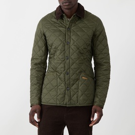 Model wearing Barbour Liddesdale Short Quilted Jacket in Olive, featuring diamond quilting, contrast brown corduroy collar and snap button fastening