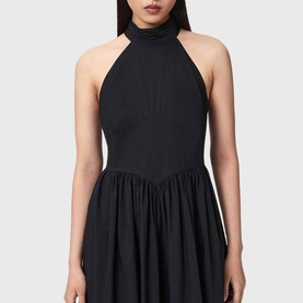 Model wearing All Saints black halterneck dress with gathered skirt and high neck, open back design