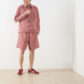 Model wearing Farah Vintage Mattison Denim Jacket in Dusty Red with matching shorts and burgundy trainers.