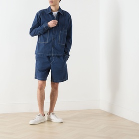 Model wearing Farah Vintage Mattison Denim Jacket in Aegean Blue with matching denim shorts and white trainers.