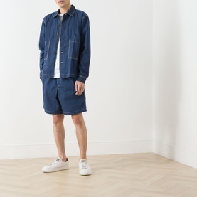 Model wearing Farah Vintage Mattison Denim Jacket in Aegean Blue with matching denim shorts and white trainers
