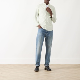 Model wearing Farah Vintage Brewer Logo Shirt in Soft Green with blue wash jeans and black loafers