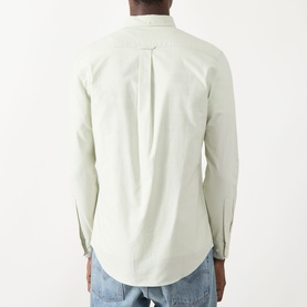 Model wearing Farah Vintage Brewer Logo Shirt in Soft Green, rear view showing curved hem and centre back pleat, styled with light wash jeans