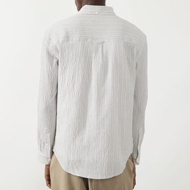 Model wearing Farah Vintage Stone Grey casual shirt, rear view, textured stripe cotton fabric, long sleeves, styled with beige trousers.