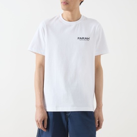 Model wearing Farah Vintage Clissold Logo T-Shirt in white, crew neck, short sleeves, with small chest logo print, styled with blue jeans.