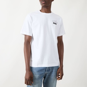 Model wearing Farah Vintage Logo Back Graphic T-Shirt in white, crew neck, short sleeves, styled with light blue jeans.