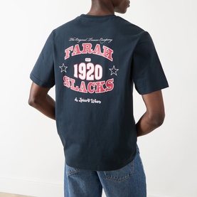 Model wearing Farah Vintage Caligo Logo T-Shirt in True Navy, showing back graphic with Farah Slacks 1920 print, crew neck, short sleeves.