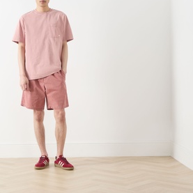Model wearing Farah Vintage Stacy Logo Pocket T-Shirt in Dusty Red with matching shorts and red trainers.