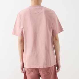 Model wearing Farah Vintage Stacy Logo Pocket T-Shirt in Dusty Red, rear view, short sleeves, straight hem, paired with pink trousers.