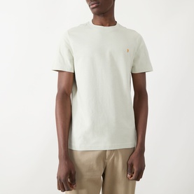 Model wearing Farah Vintage Danny Logo T-Shirt in Soft Green, crew neck, short sleeves, small chest logo, styled with beige chinos.