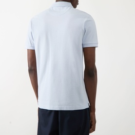 Model wearing Farah Vintage Blanes Logo Polo Shirt in Blue Nickle, rear view, styled with navy shorts.