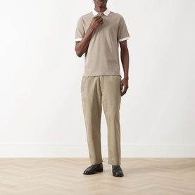 Model wearing Farah Vintage Clement Logo Contrast Collar Polo Shirt in Stone Grey, styled with khaki trousers and black loafers.