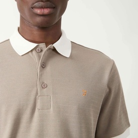 Model wearing Farah Vintage Clement Logo Contrast Collar Polo Shirt in Stone Grey with white contrast collar and embroidered logo detail.